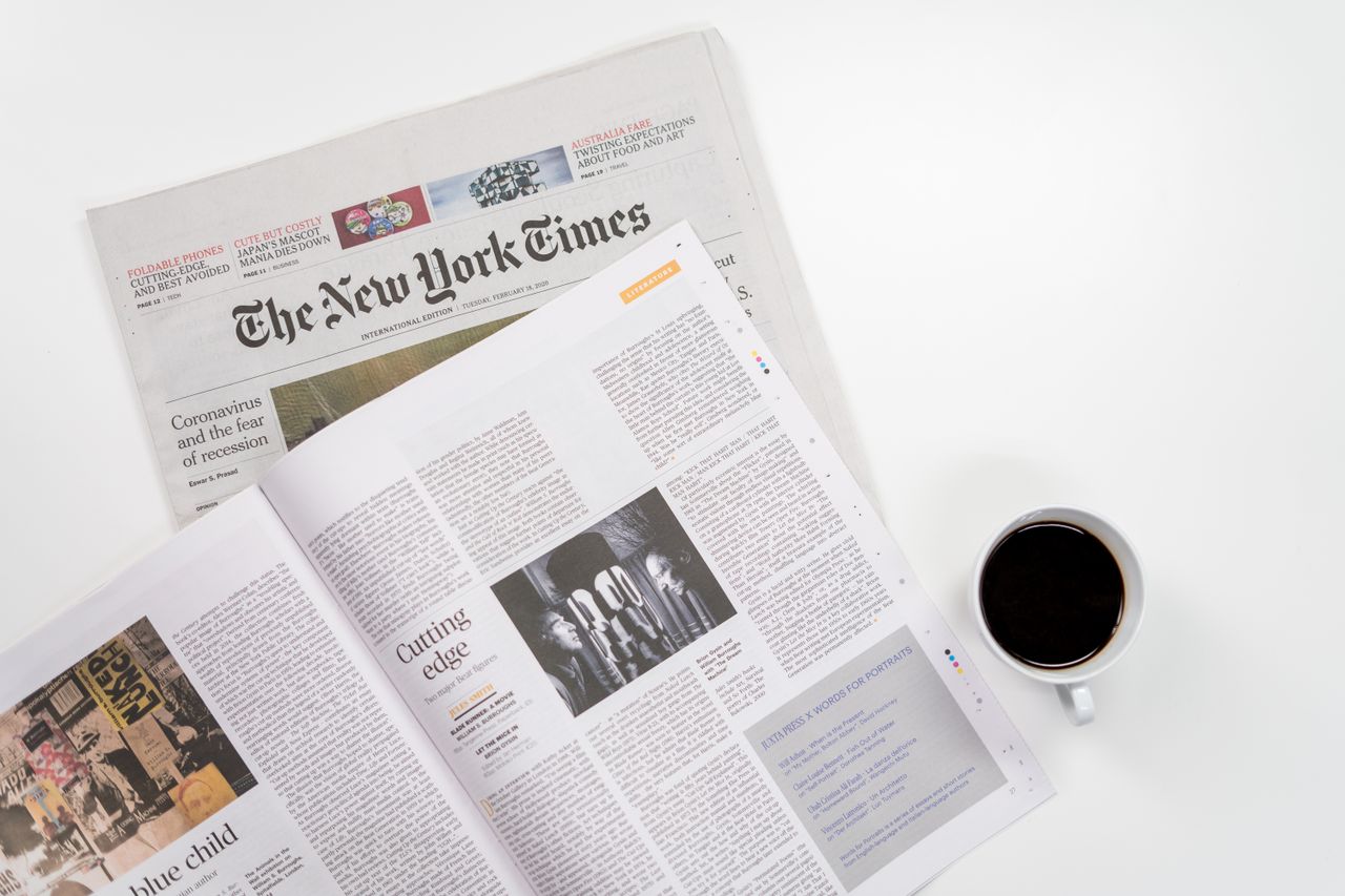 services-05 Flat lay of a coffee cup and The New York Times newspaper, ideal for business and lifestyle themes.