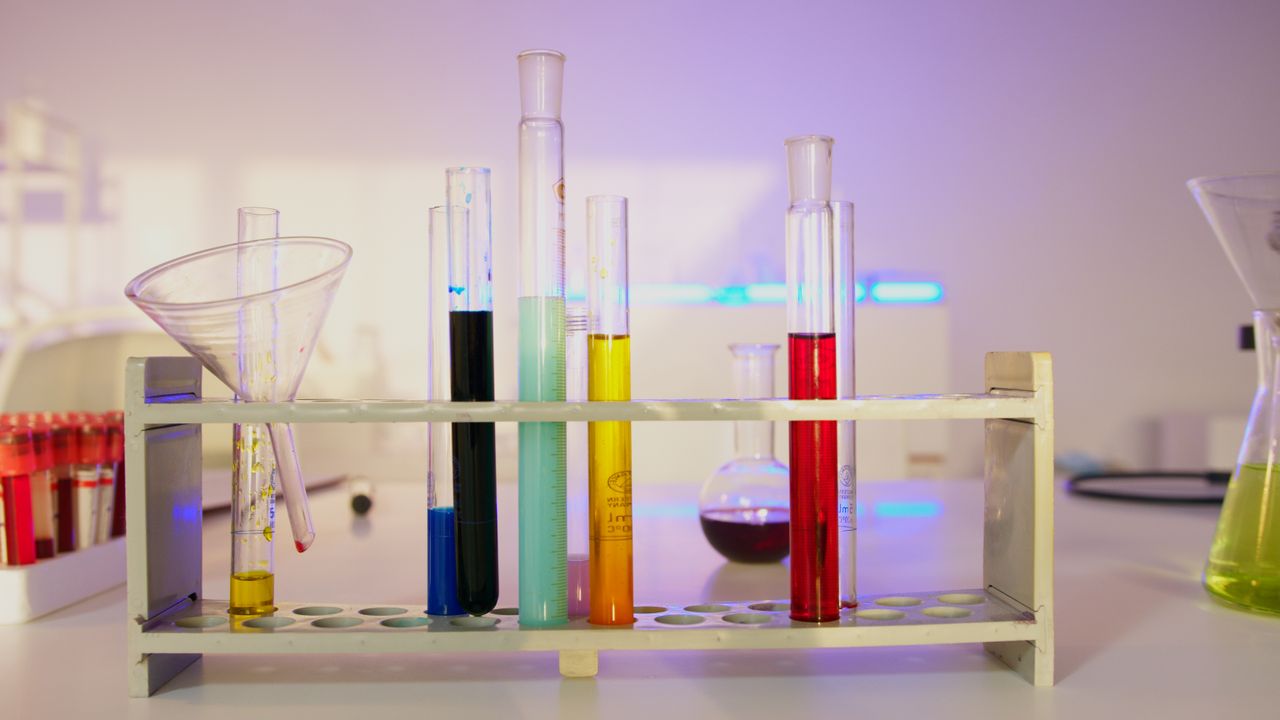 services-01 Vibrant test tubes filled with liquids in a modern lab setting, showcasing scientific exploration.